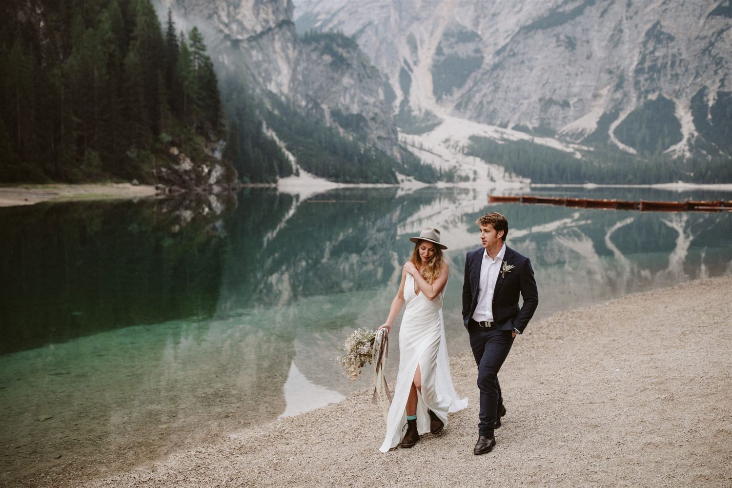 Bride and groom walking through the hidden gem of Italy The Dolomites Wedding Anna Galloway Photography