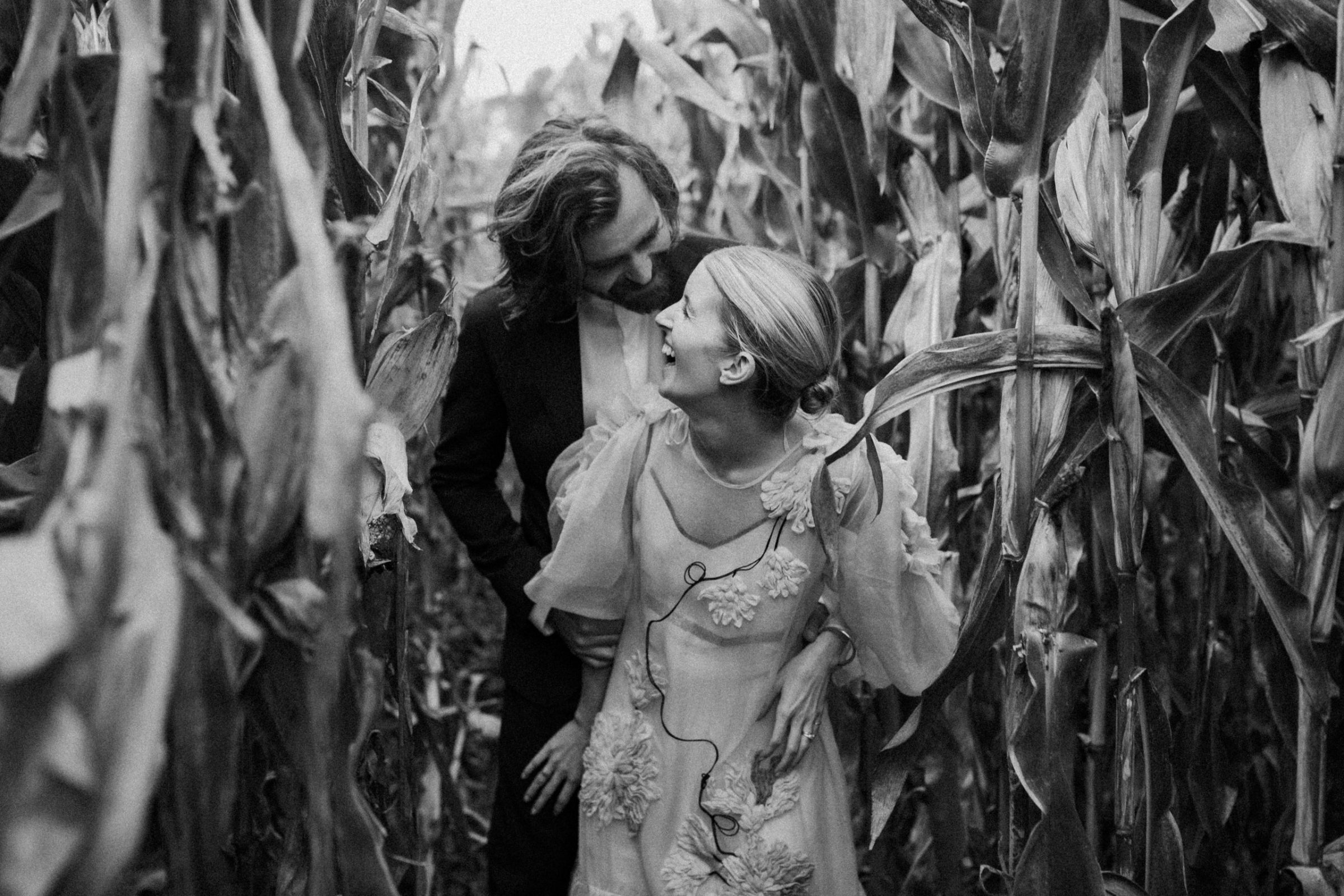 Bride and groom happily walking through the corn field at intimate Hawke's Bay Wedding Ana Galloway Photography