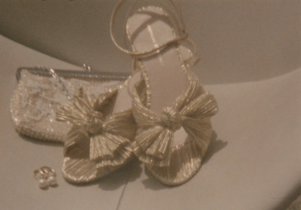 Still frame from a super 8 film footage showing wedding shows and vintage clutch