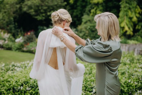 Mother of the bride tying a box in silk chiffon dress Ana Galloway Photography