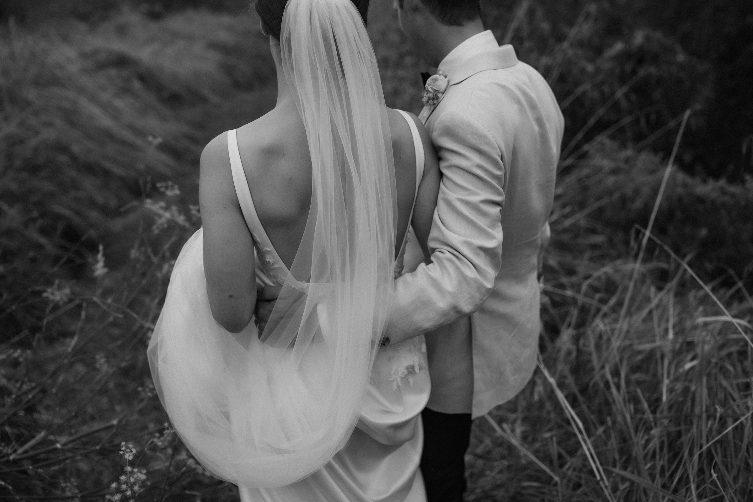 Close up of bride and groom walking arm and arm away from the camera Hawkes Bay Wedding Ana Galloway Photography