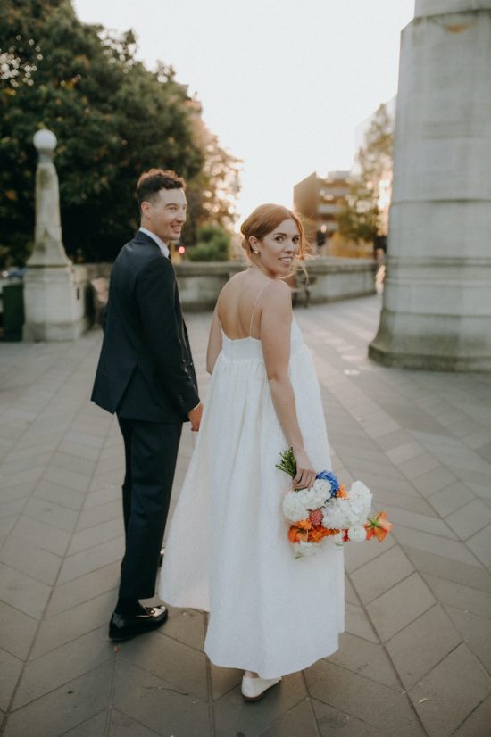 Bride and groom walking the streets at sunset Inner City Wedding Christchurch Wedding Ana Galloway Photography